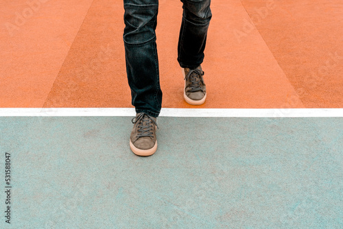 Φωτογραφία Man stepping over a white line