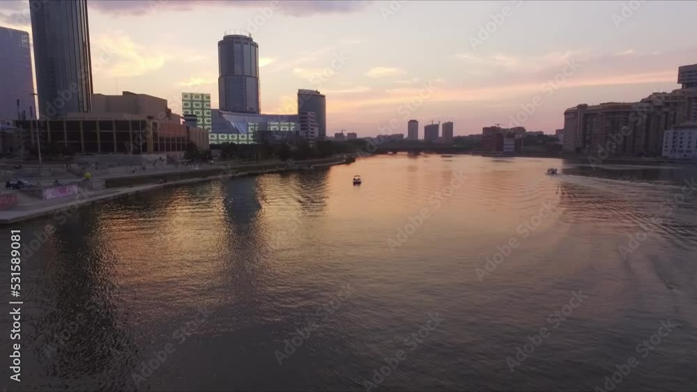 Aerial shot of river in city against sky during sunset, The boat is moving slowly, People are walking on the embankment, boats are floating on the river. Dusk wonderful colors of the sky
Aerial shot of river in city against sky during sunset, The boat is moving slowly, People are walking on the embankment, boats are floating on the river. Dusk wonderful colors of the sky