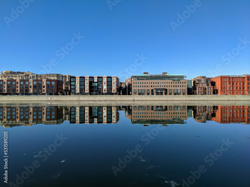 Moscow, Russia - March 01, 2022: Beautiful view of the embankment of the Muzeon park against the blue sky. Houses are reflected in the Moscow River. Copy space photo