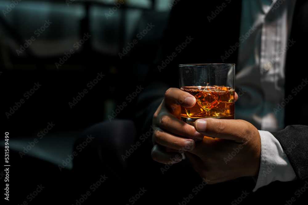 Closeup businessmen holding a glass of whiskey