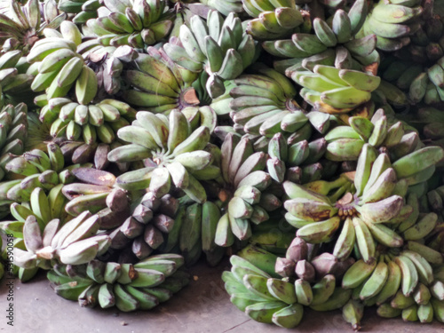 a bunch of bananas on concrete floor at farmer market. © Ekahardiwito