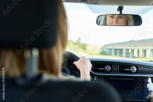 Caucasian blonde woman driving a car