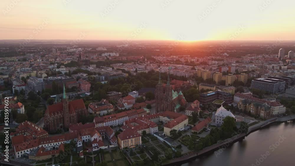 Drone flight over Tumski island and Cathedral of St John the Baptist in Wroclaw at morning sunrise light, Aerial view of old town with historical architecture in Wroclaw city, Poland Drone flight over Tumski island and Cathedral of St John the Baptist in Wroclaw at morning sunrise light, Aerial view of old town with historical architecture in Wroclaw city, Poland