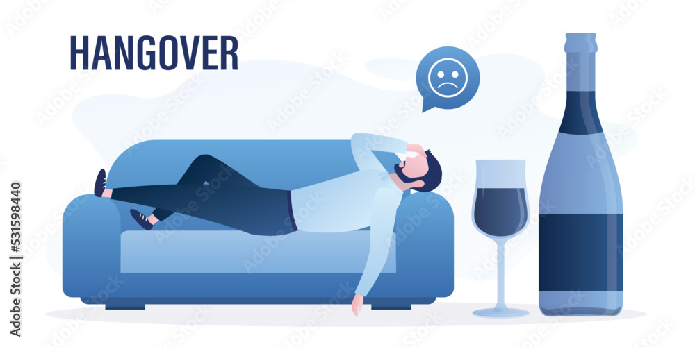 Hangover, unhappy man lies on couch with headache. Health problems after night party. Addiction to alcohol. Large bottle of wine and glass. Excessive alcohol consumption. Hangover, unhappy man lies on couch with headache. Health problems after night party. Addiction to alcohol. Large bottle of wine and glass. Excessive alcohol consumption.