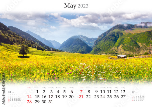 Wall calendar for 2023 year. May, B3 size. Set of calendars with amazing landscapes. Blooming yellow flowers on alpine meadows in Caucasus mountains, Georgia. Monthly calendar ready for print.
