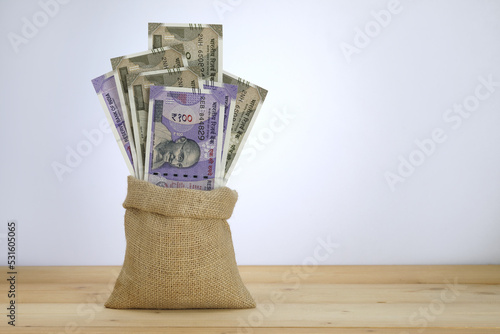 Rs. 100 and Rs. 500 notes in a jute sack.