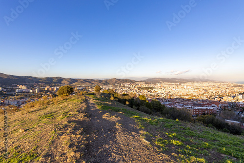Barcelona skyline at sunny day. City landscape view from the mountain. © Sergei