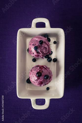 blueberry icecreame cones on a white plate froma bove photo