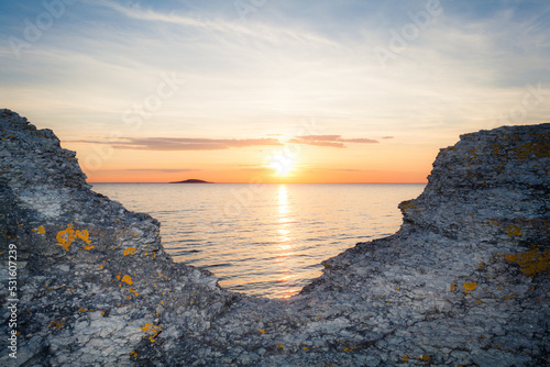 sunset by Byrums raukar sea horizon cliff formations photo