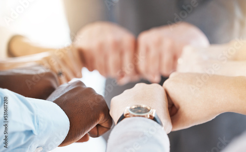Diversity business hands fist bump for teamwork, collaboration or solidarity in corporate workplace. Group of people and hand sign icon for community, working together or inclusion support background