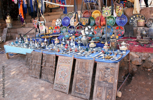 Traditional moroccan souvenirs - plate, dagger, jug, vintage wooden shutters, souk in Ait-Ben-Haddou Kasbah, Morocco