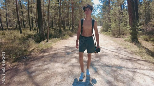 total wide front shot young shirtless teenage walking in forest in fontainebleau photo