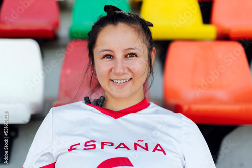 Smiling young player wearing sports jersey at stadium