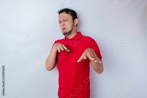 Attractive Asian man with hand gesture pose rejection or prohibition with copy space