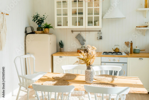 Bright spacious dining room with wooden big table
