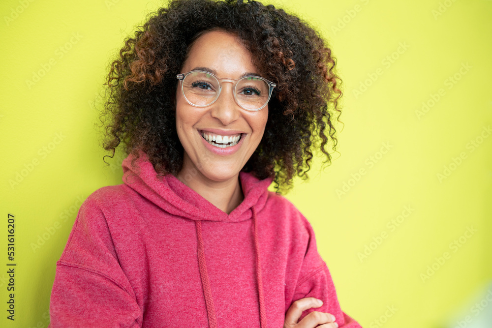 Happy woman with eyeglasses in front of green wall Happy woman with eyeglasses in front of green wall