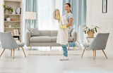 Cleaning, chores and hygiene with a woman cleaner or domestic worker with a mop in a house to clean, tidy and wash. Housework, hygienic and sanitizing with a young female in a home living room