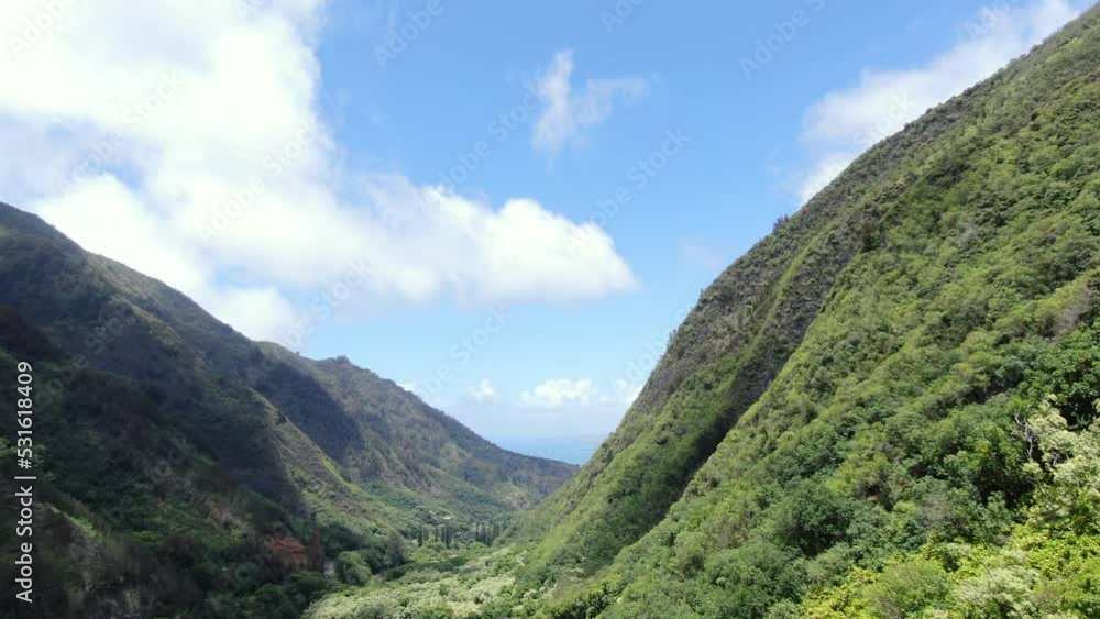 Clouds moving over the V shaped mouth of the valley in 'Iao State Park. Static aerial shot. Clouds moving over the V shaped mouth of the valley in 'Iao State Park. Static aerial shot.