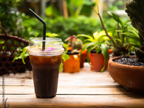 Ice Americano Black Coffee in Glass on Wooden Table,Fresh Drink for Summer Tropical,Cold Tea Drink and Sweet Have caffeine in Cafe Shop in Restaurant,Snack Food concept.