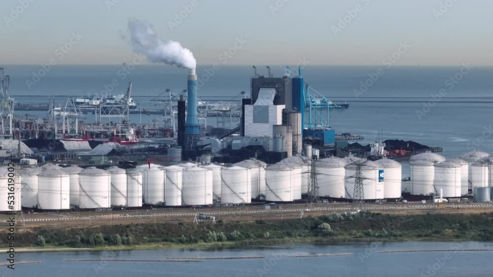 Am industrial shipyard in the Netherlands with oil storage tanks in the foreground Am industrial shipyard in the Netherlands with oil storage tanks in the foreground