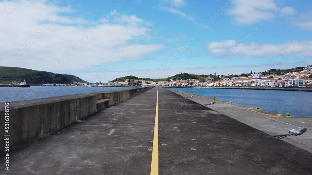 Azores dock, marine, harbor, pier, shot on gimbal slowmotion in Horta, Faial, Açores. Walking on pier of cidade da Horta, Ilha do Faial, overcast day. Azores dock, marine, harbor, pier, shot on gimbal slowmotion in Horta, Faial, Açores. Walking on pier of cidade da Horta, Ilha do Faial, overcast day.