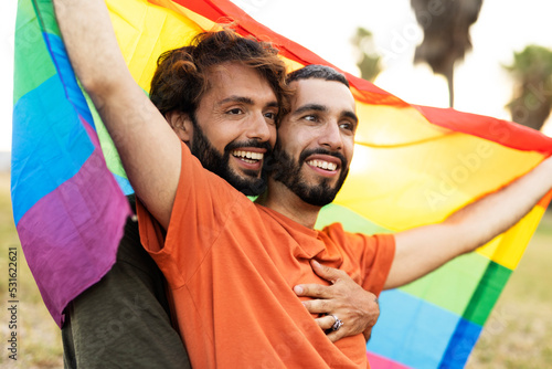 Happy couple with a pride flag. LGBT community