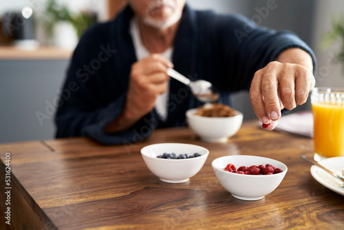 Senior caucasian man preparing breakfast at home
