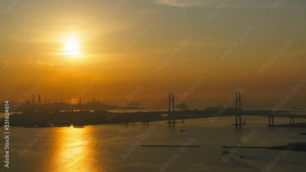 Time lapse of sunrise over Yokohama Bay Bridge over Tokyo Bay in Japan Time lapse of sunrise over Yokohama Bay Bridge over Tokyo Bay in Japan