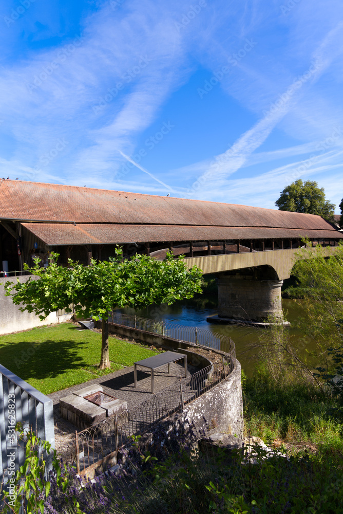 Beautiful single lane covered wooden bridge over Thur River connecting villages Andelfingen and Kleinandelfingen on a sunny summer day. Photo taken July 12t, 2022, Andelfingen, Switzerland. Beautiful single lane covered wooden bridge over Thur River connecting villages Andelfingen and Kleinandelfingen on a sunny summer day. Photo taken July 12t, 2022, Andelfingen, Switzerland.