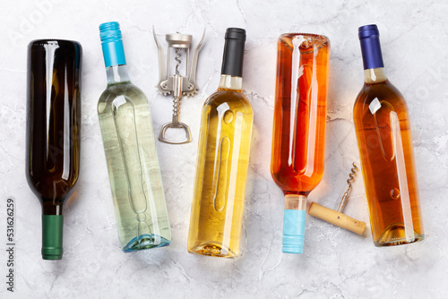 Various wine bottles and corkscrews