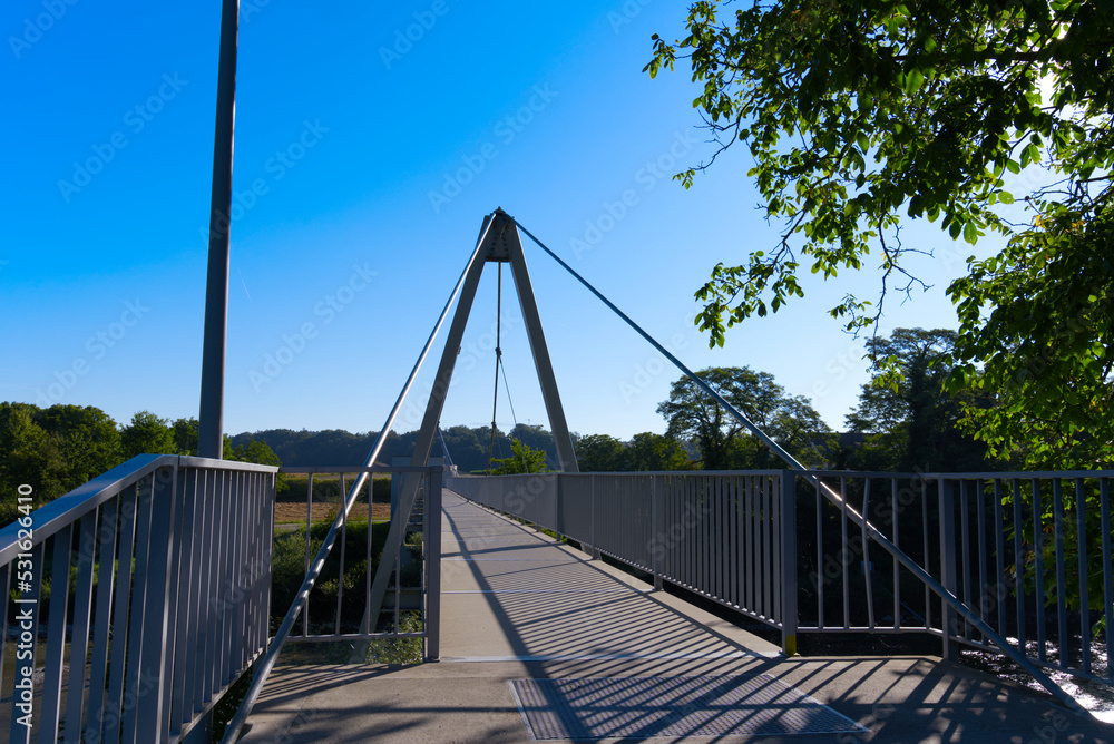 Pedestrian rope bridge over Thur River at village Kleinandelfingen, Canton Zürich, on a sunny summer morning. Photo taken July 12th, 2022, Kleinandelfingen, Switzerland. Pedestrian rope bridge over Thur River at village Kleinandelfingen, Canton Zürich, on a sunny summer morning. Photo taken July 12th, 2022, Kleinandelfingen, Switzerland.