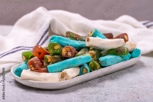 Assortment of Turkish delight with pistachio wick on a gray background. Traditional Turkish cuisine delicacies. close up
