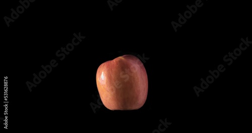 Fresh red apple spinning with a black transparent background, isolated photo