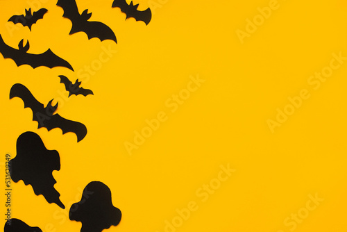 Happy Halloween  Halloween flat lay. Bats and ghosts decoration on yellow.Minimal halloween template