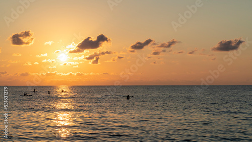 Bright sunset with large yellow sun under the sea surface. © Michael