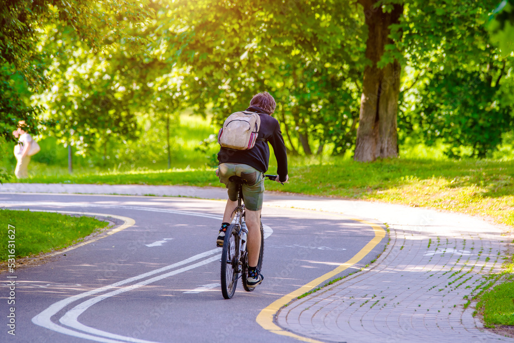 Cyclist ride on the bike path in the city Park