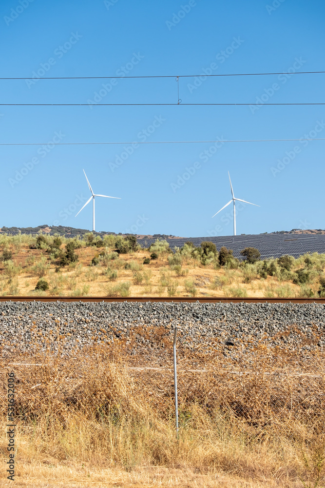 Solar energy panel photovoltaic cell and wind turbine farm power generator in nature landscape.