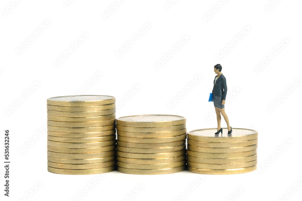 Miniature people toy figure photography. Salary growth concept. Businesswoman standing above stair coin money stack