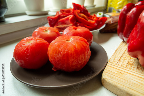 Fotografie Scalded peeled red tomatoes on a plate as an ingredient
