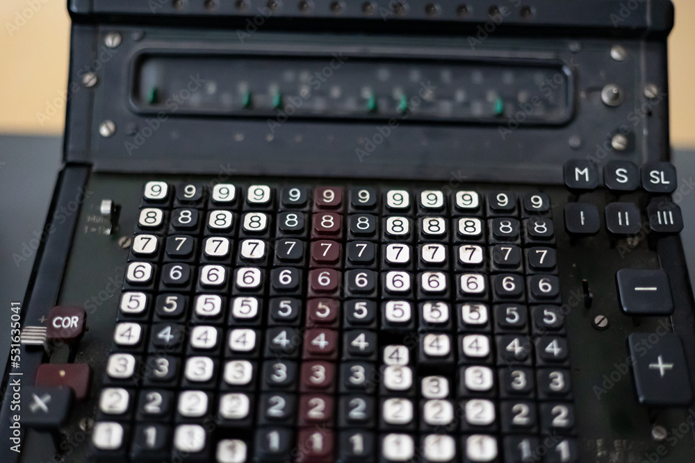 Old calculating machine. Close-up of an old analog calculating machine. Historical equipment to calculate numbers. Old calculating machine. Close-up of an old analog calculating machine. Historical equipment to calculate numbers.
