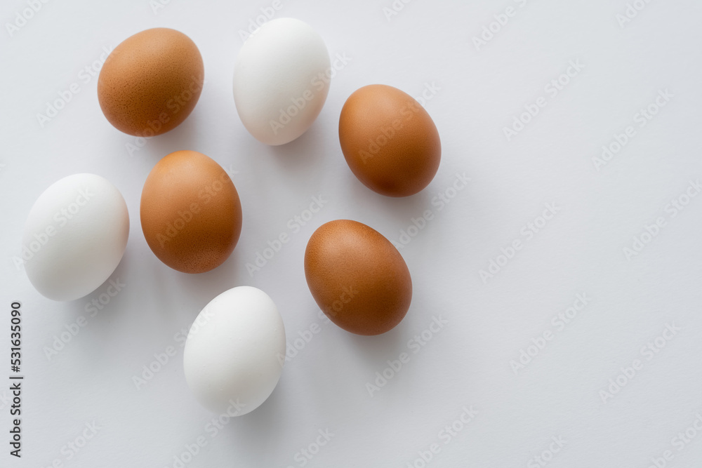 Top view of organic chicken eggs on white background. Top view of organic chicken eggs on white background.