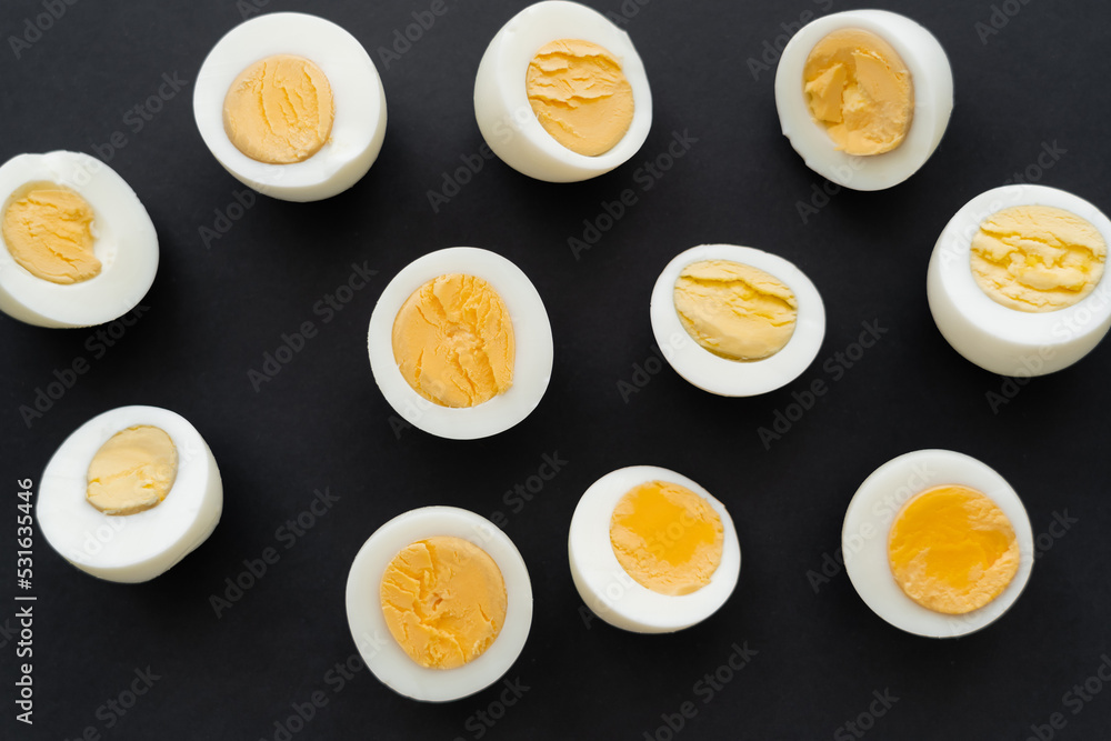 Top view of organic boiled eggs on black background. Top view of organic boiled eggs on black background.
