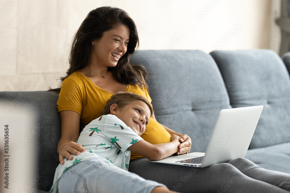 Son put his head on pregnant moms belly while she works Son put his head on pregnant moms belly while she works