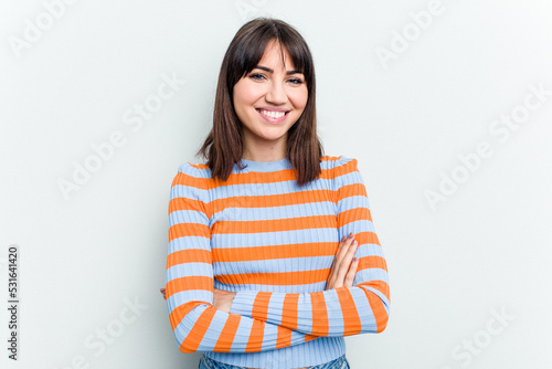 Young caucasian woman isolated on white background who feels confident, crossing arms with determination.