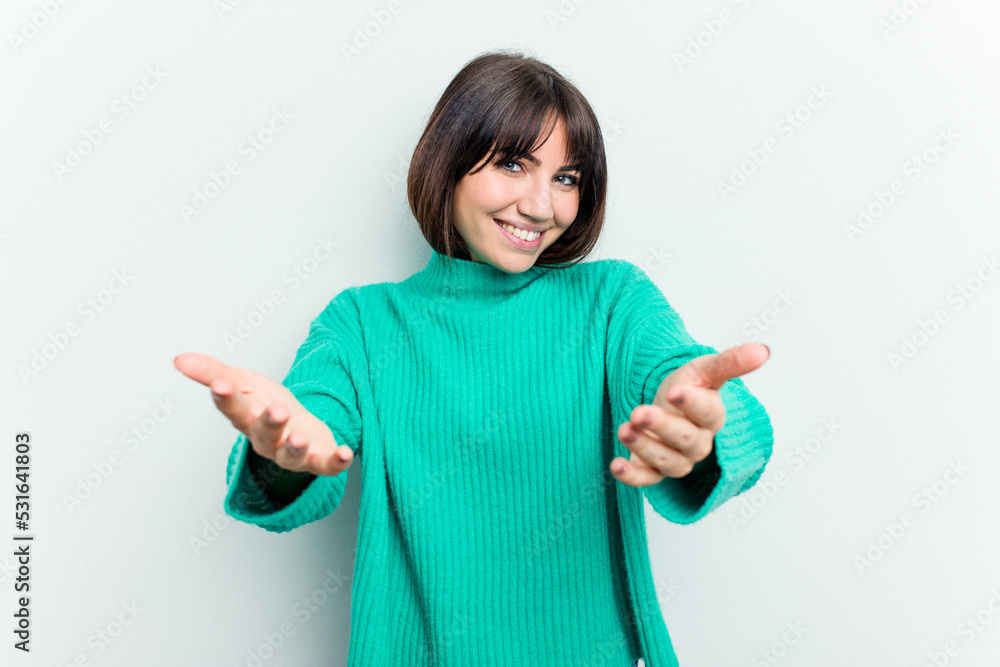 Young caucasian woman isolated on white background showing a welcome expression. Young caucasian woman isolated on white background showing a welcome expression.