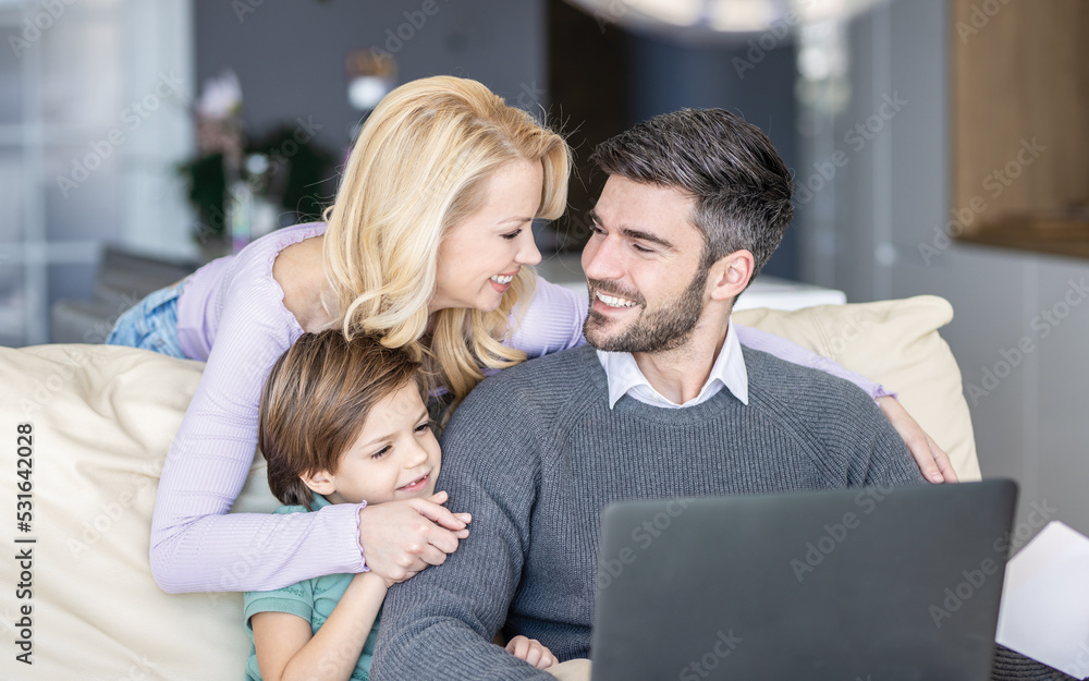 Three member family havign their time in living room
Father is working remotely Three member family havign their time in living room
Father is working remotely