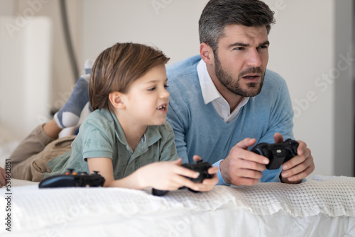 father and child playing video games