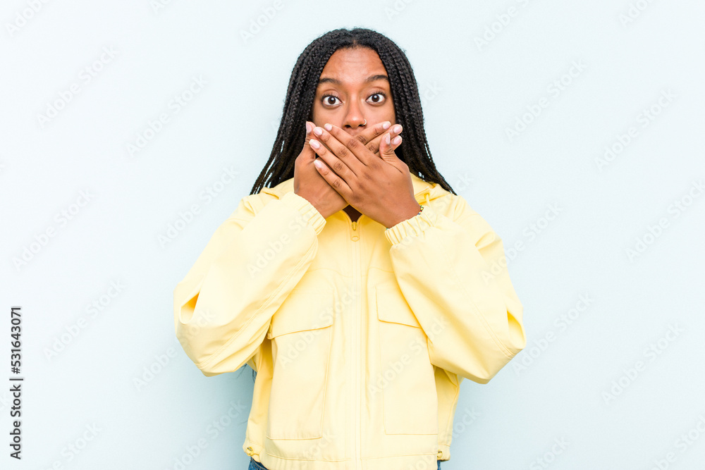 Young African American woman with braids hair isolated on blue background covering mouth with hands looking worried. Young African American woman with braids hair isolated on blue background covering mouth with hands looking worried.