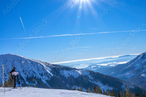 Skier with a Map on a Sunny Ski Slope