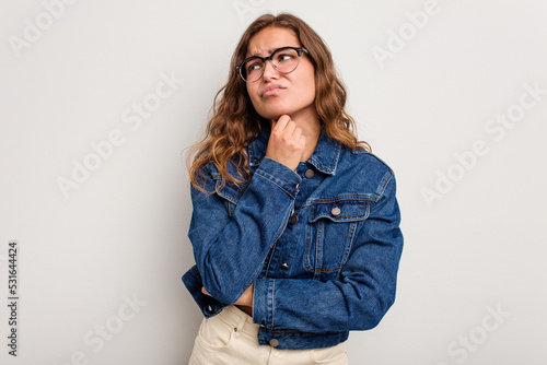 Young caucasian woman isolated on blue background suffers pain in throat due a virus or infection.